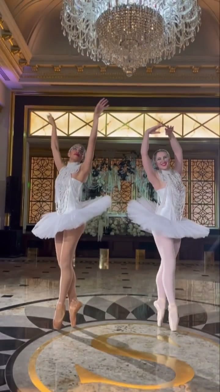 Two ballerinas en pointe in white tutus at a luxury venue in New York