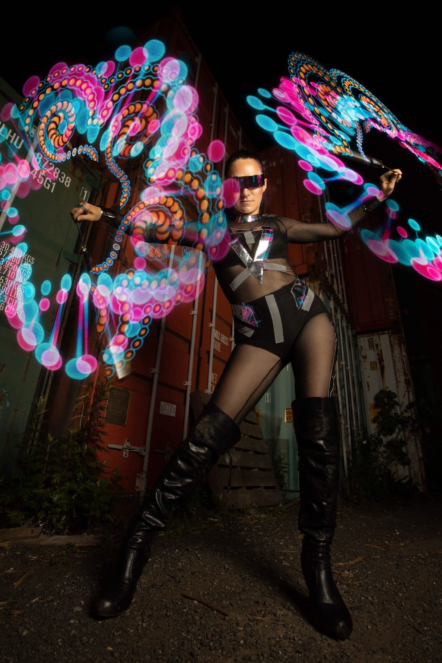 LED poi spinner performing a kinetic light show at an upscale evening event