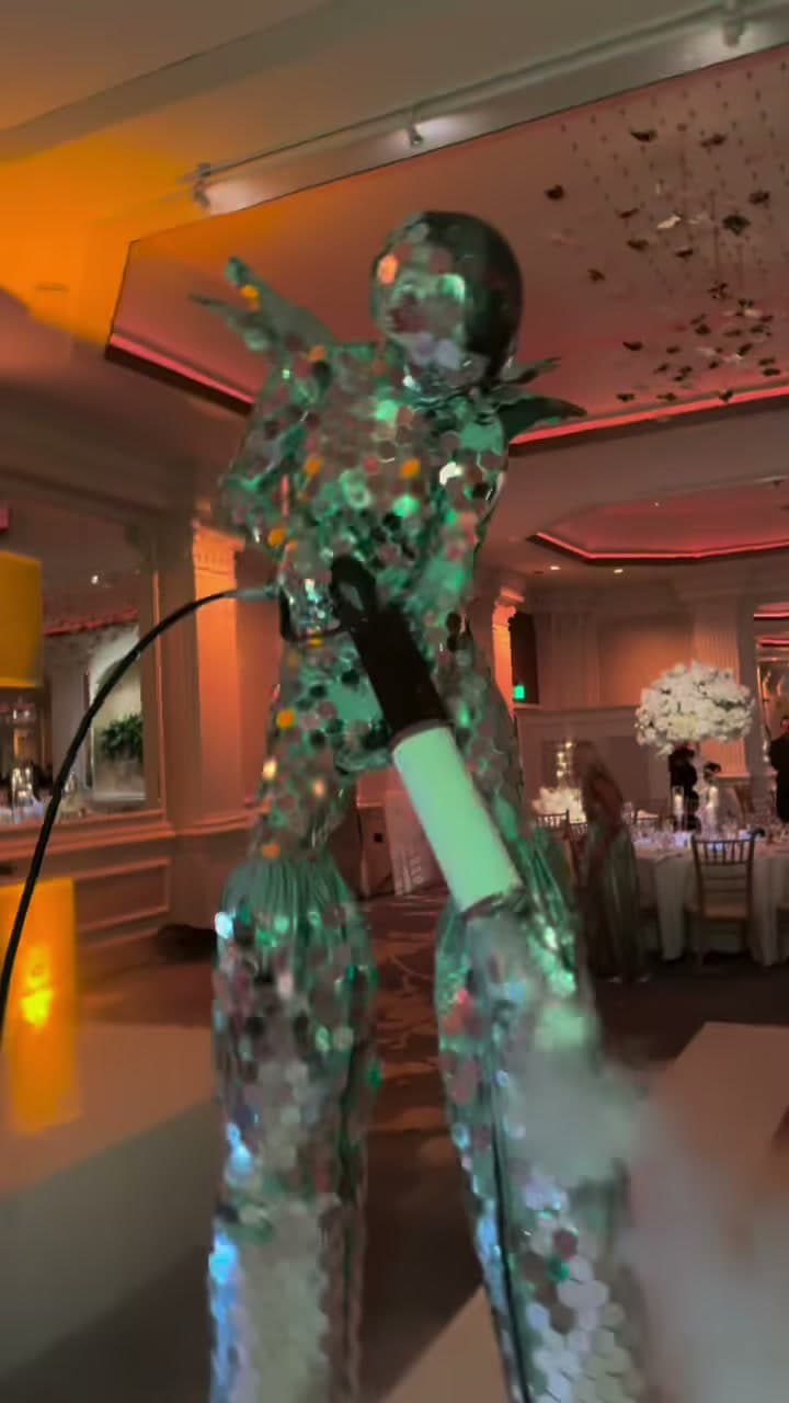 Life size mirror bot performer in sequined mirror disco costume at a ballroom event in New York