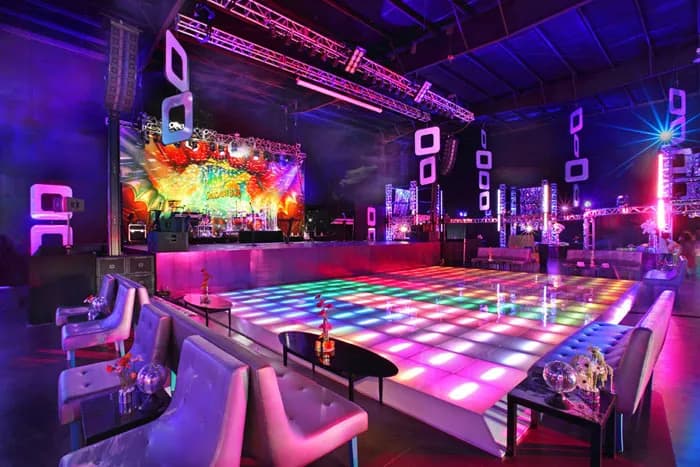 LED checkered light-up dance floor glowing under custom lighting at a Sweet 16 celebration