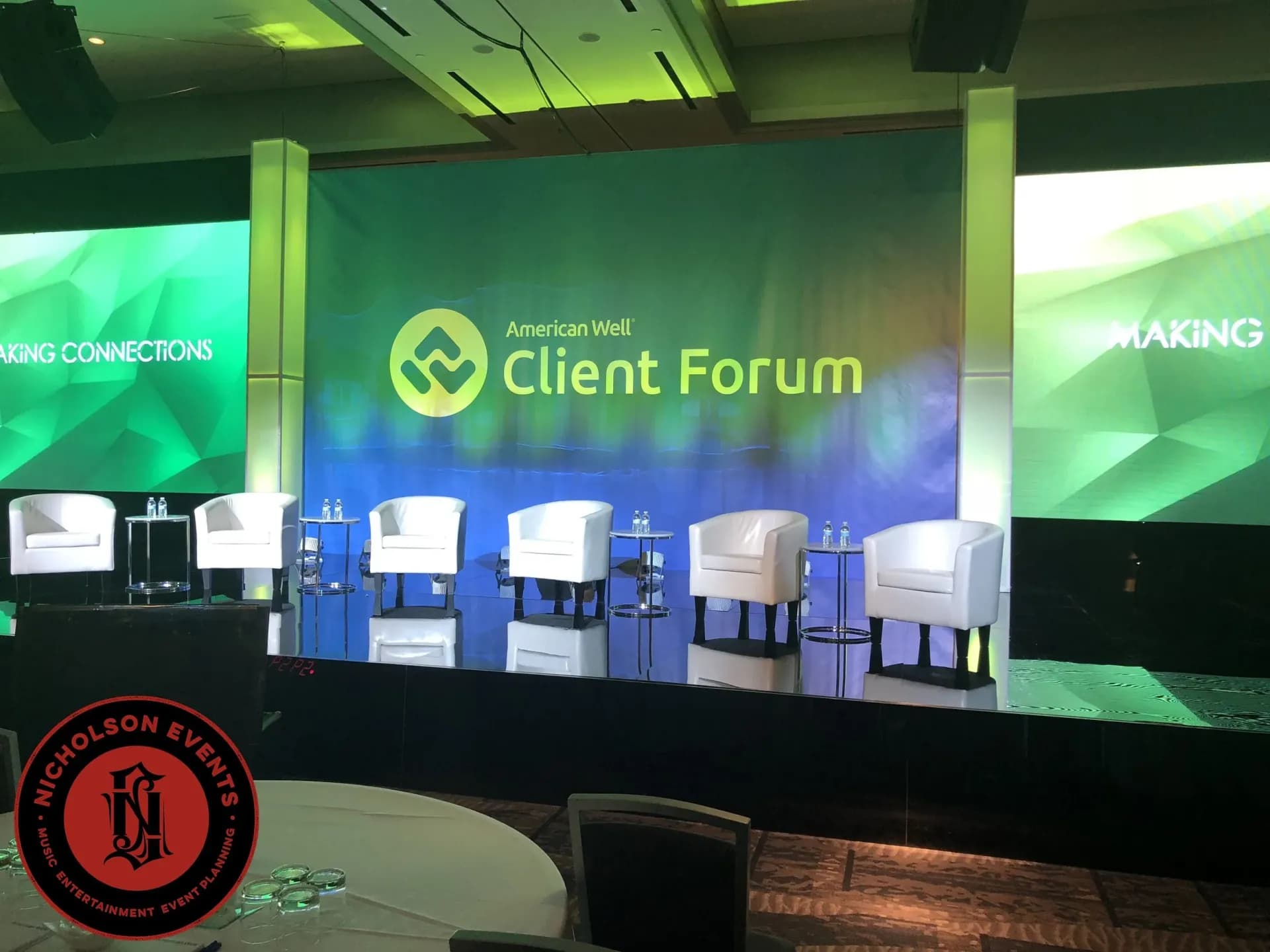 Corporate stage build with LED screens and a branded backdrop
