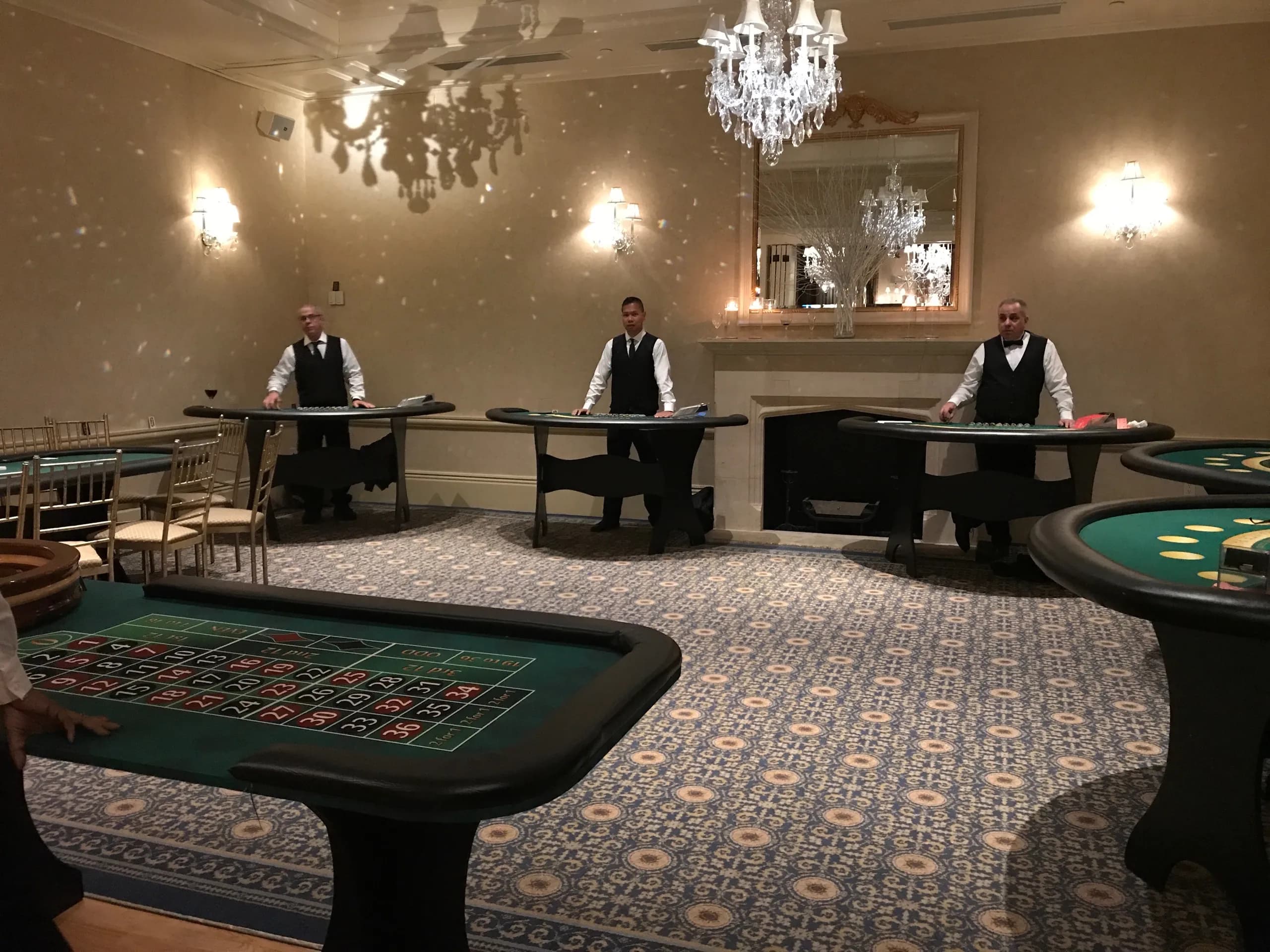 Full casino party setup with blackjack and roulette tables and professional dealers in an elegant Connecticut ballroom