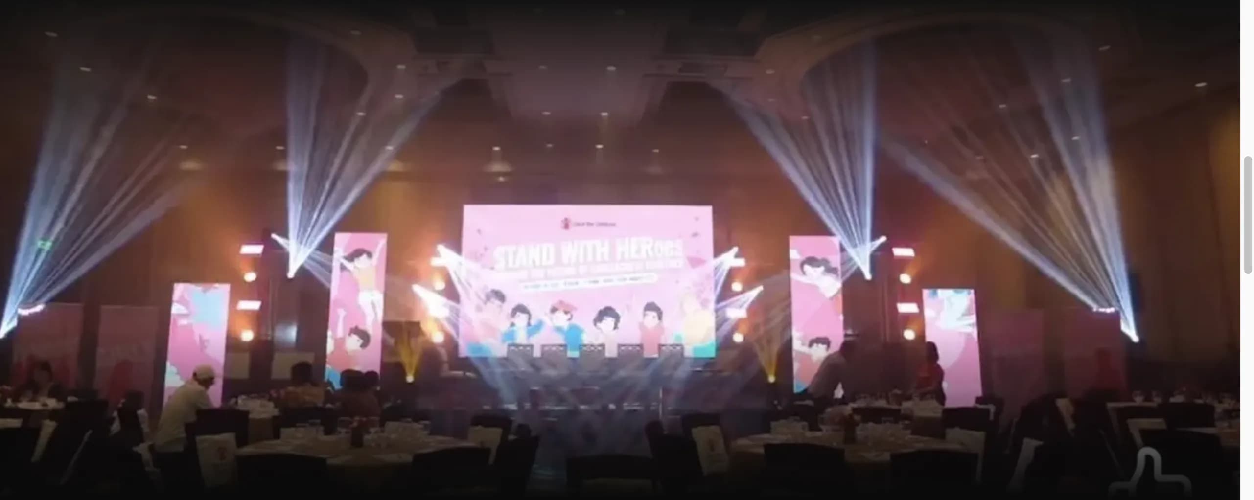 Grand ballroom gala with a large LED video wall stage and beam lighting by Nicholson Events