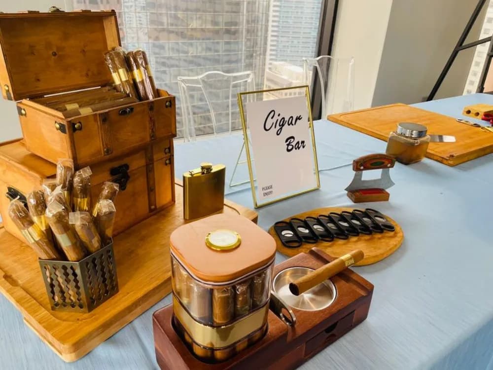Master cigar roller hand-rolling premium cigars on site at an upscale event lounge station