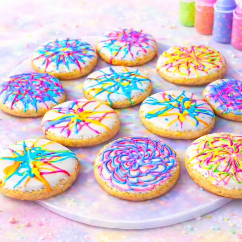 Cookie spin art station with colorful spin-painted iced cookies at a party