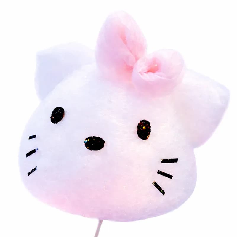 Cotton candy art hand-shaped into a white cat face with a pink bow and glittery whiskers