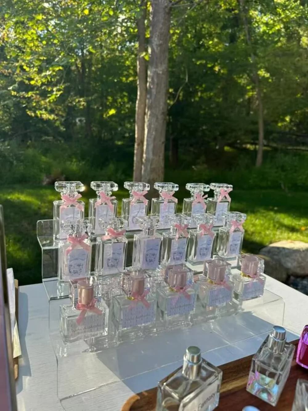 Guests blending custom perfume and cologne with an artist at an elegant event perfume bar station