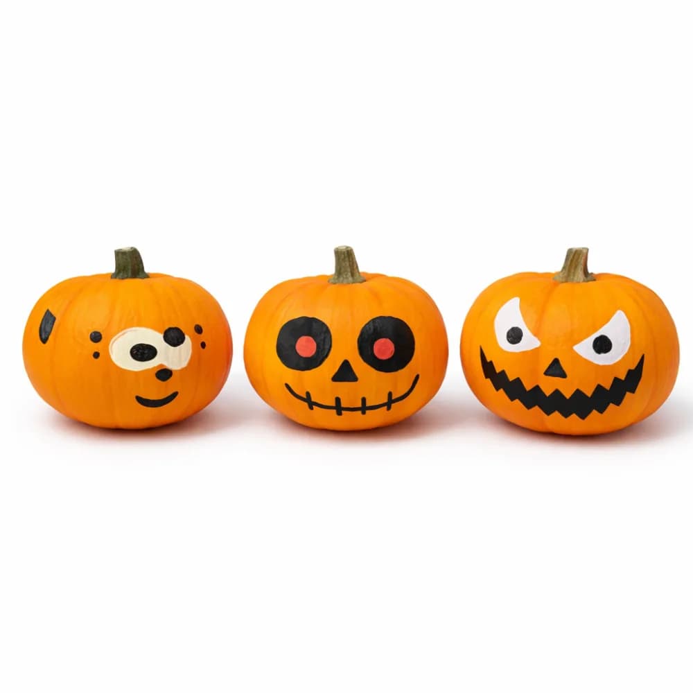 Pumpkin painting station with decorated pumpkins at a fall event