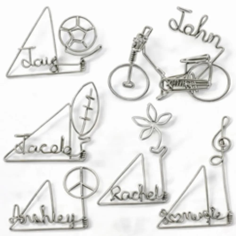 Wire art station bending guest names into wire keepsakes at a party