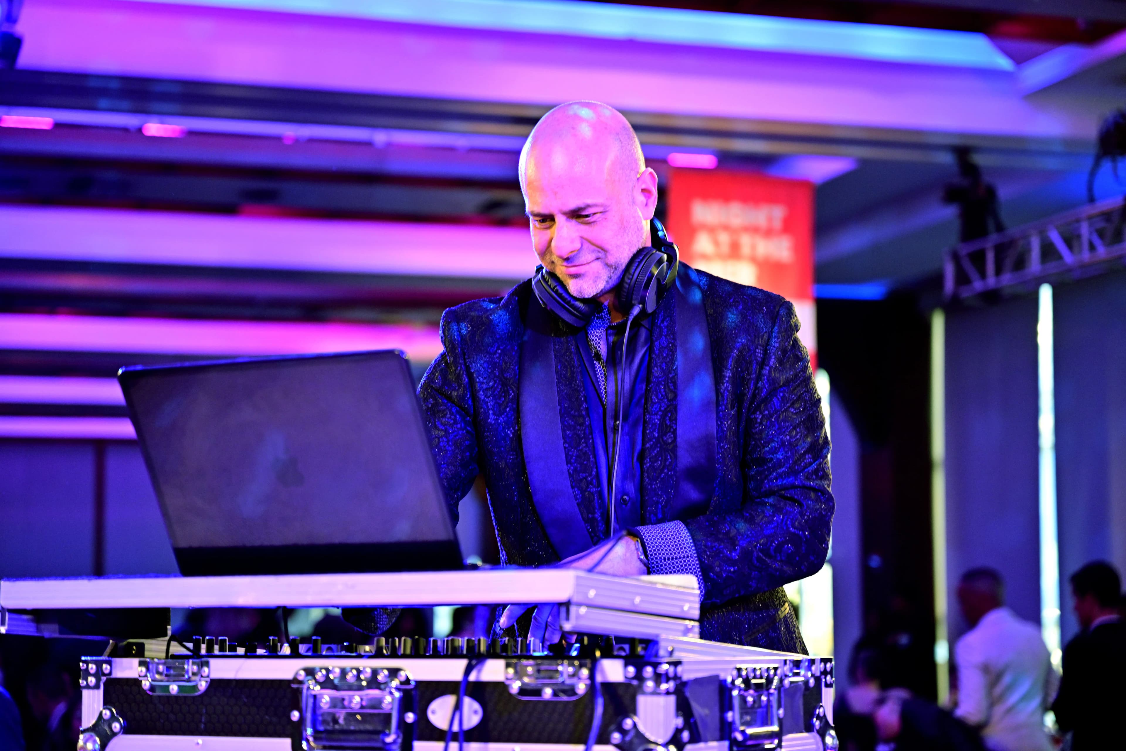 Shiran Nicholson behind the decks under full production lighting at a Nicholson Events gala