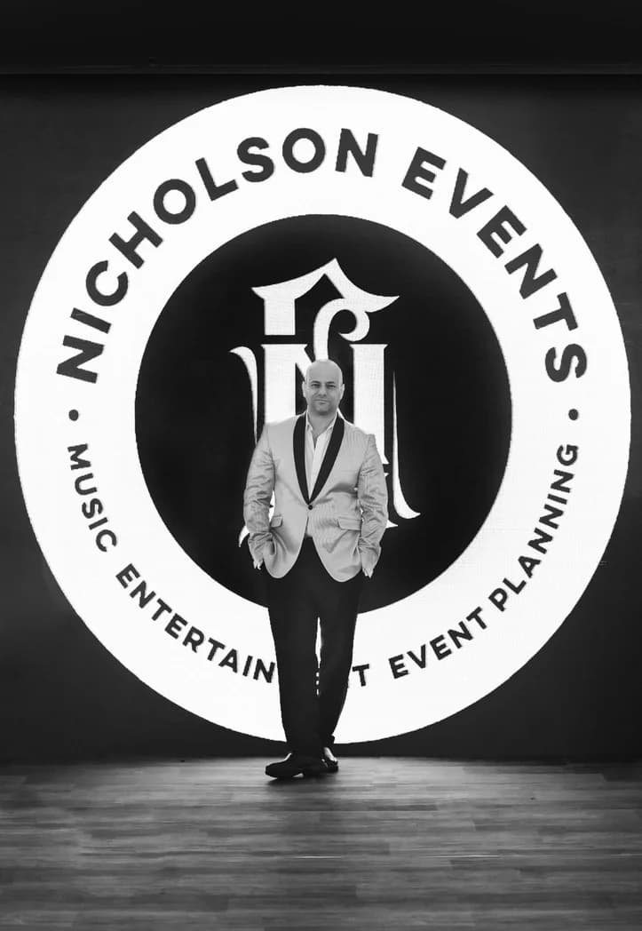 Founder Shiran Nicholson in a black and white portrait at the Nicholson Events logo wall