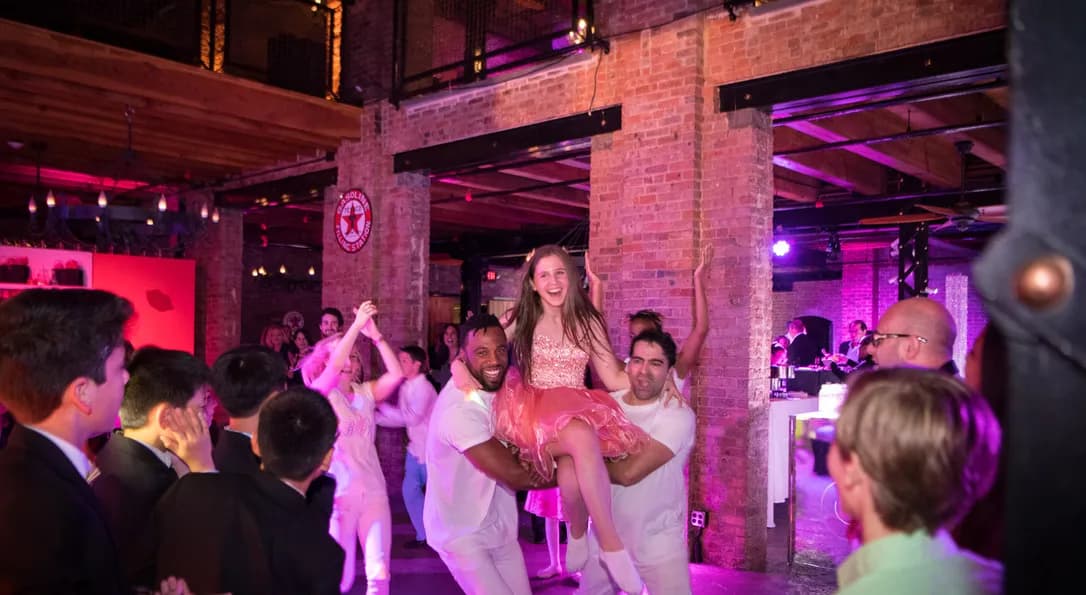 Dancers performing a grand entrance carry-in at a bat mitzvah