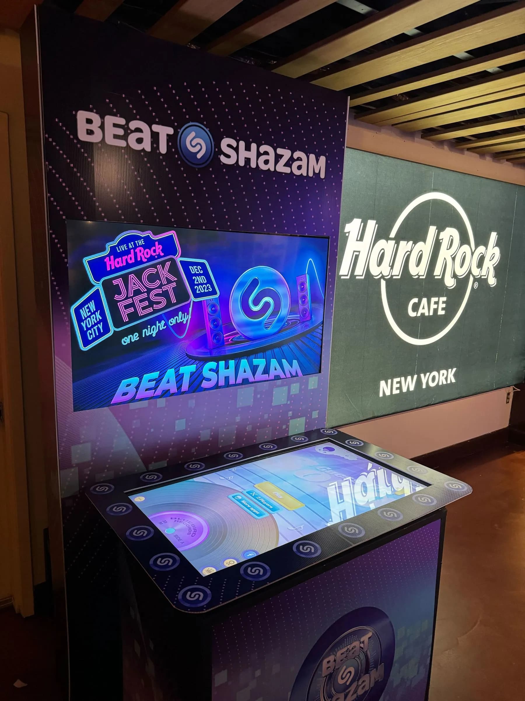 Beat Shazam-style music recognition game show kiosk with illuminated screen and interactive touch table at a live event in New York