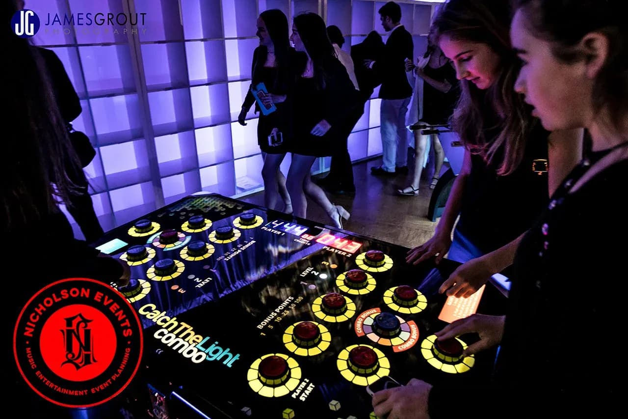 Close-up of the catch the light reaction buttons lighting up during fast head-to-head play at a mitzvah or corporate event in NYC