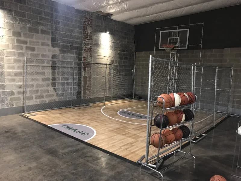 Enclosed street basketball cage setup at a bar mitzvah or corporate event in New York, contained 3-on-3 court with lower hoops