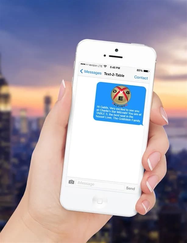 Text to table digital display game at a mitzvah or corporate event, guests texting messages that appear live on a large LED screen