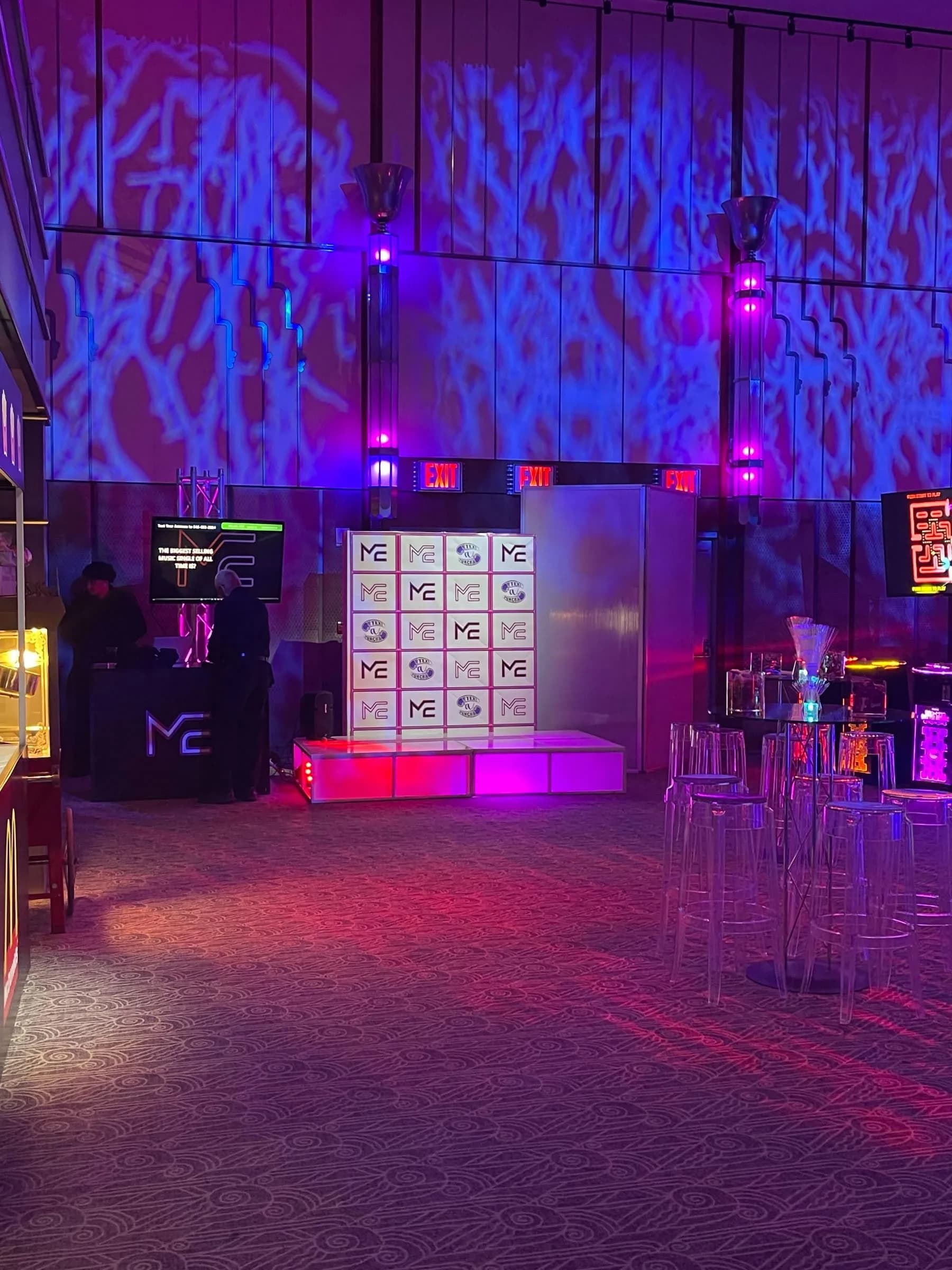 Text-to-win interactive trivia game show at a bar mitzvah, guests texting answers to compete and punch prize cubbies when they win