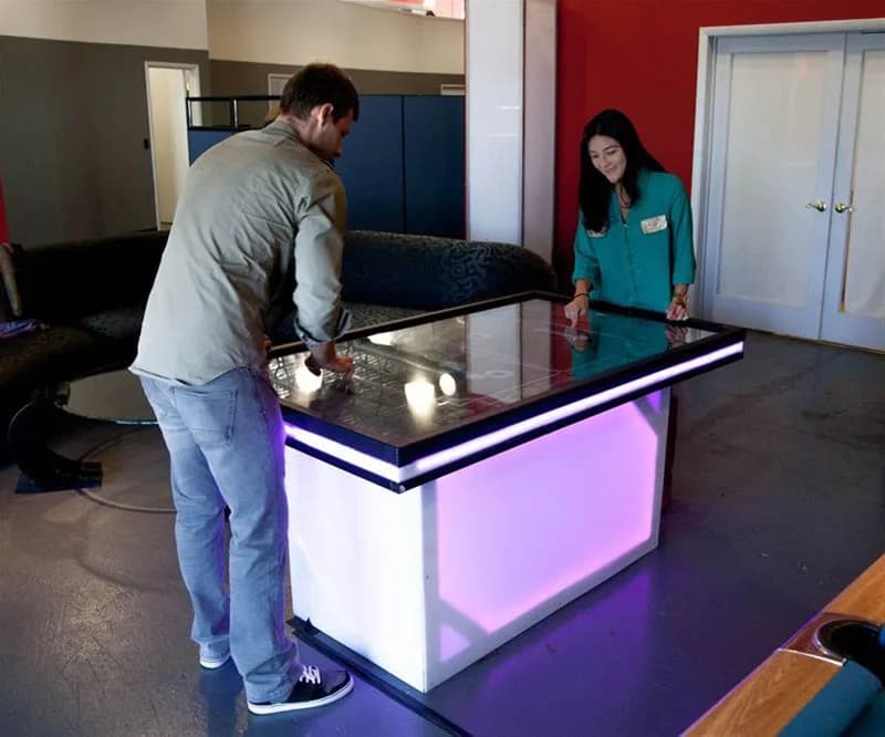 Touch game table lit up with a custom koi pond game display at a mitzvah event in Westchester or Fairfield County