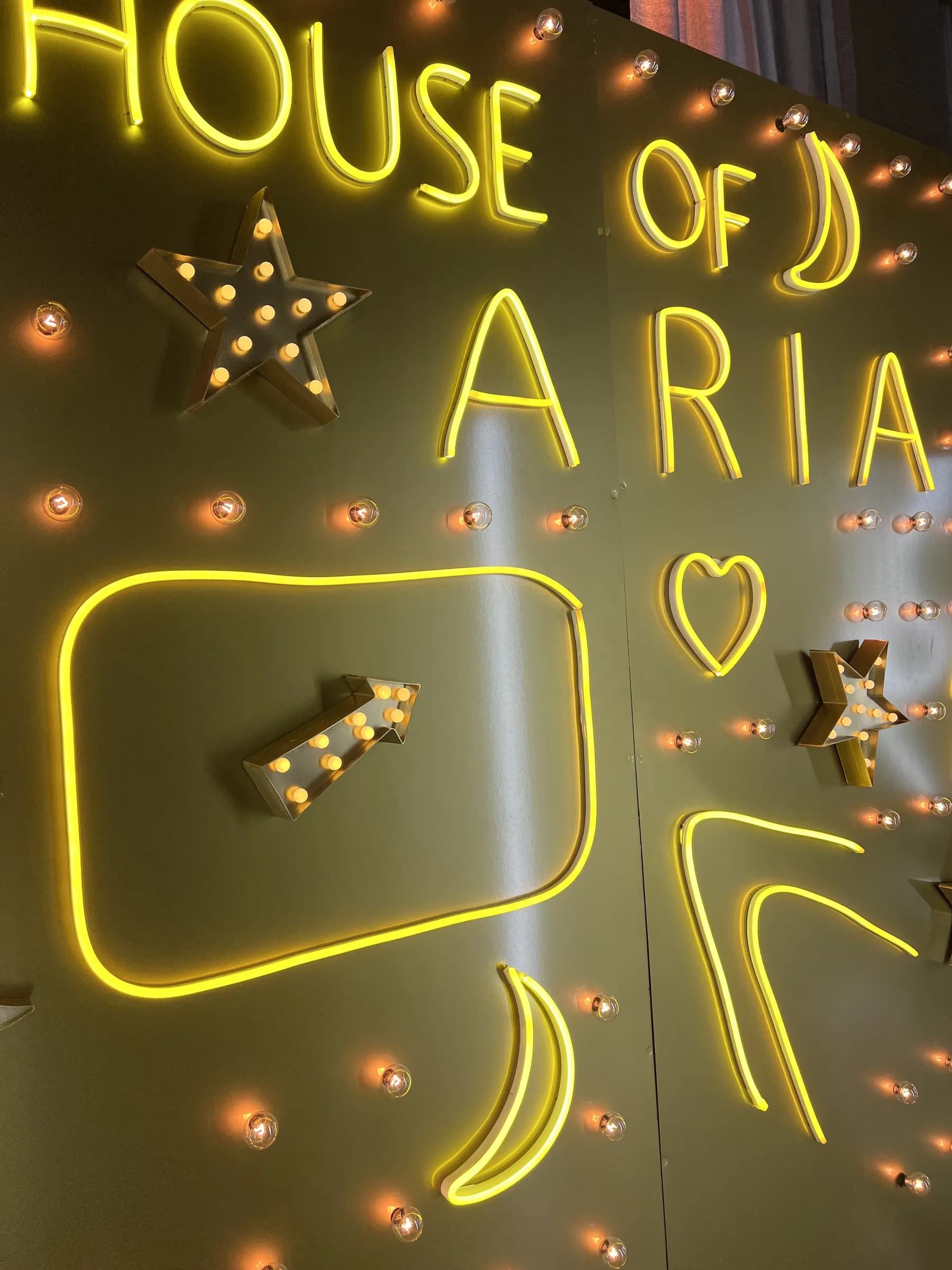 Guests posing in the Gold Neon Room immersive photo environment