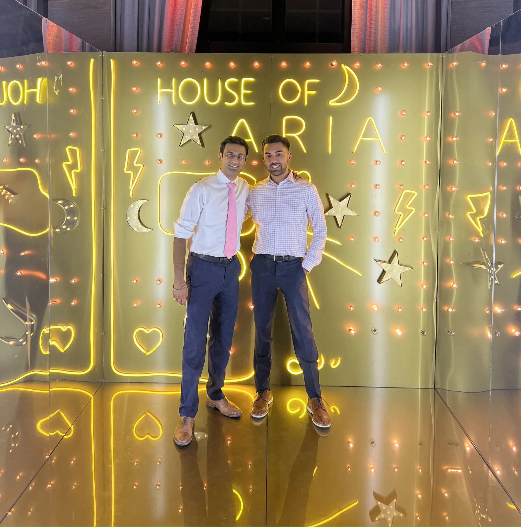 Friends posing together in the Gold Neon Room at a sweet 16 party