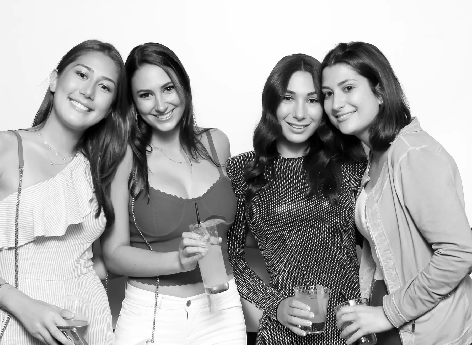 Black-and-white glam booth fashion photo of guests posing at an upscale event