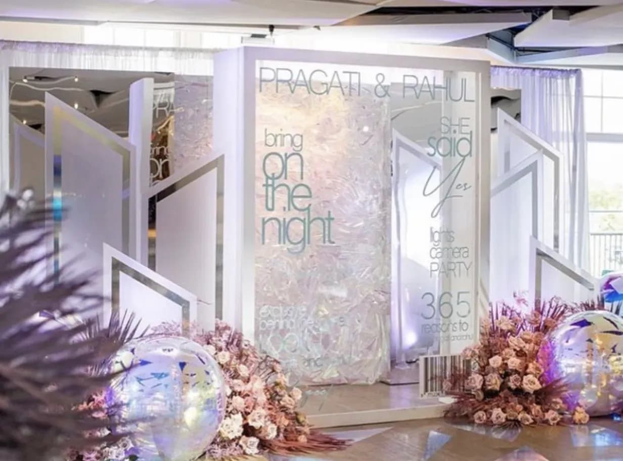 Magazine cover photo booth with a luxury floral backdrop and city view at an upscale event