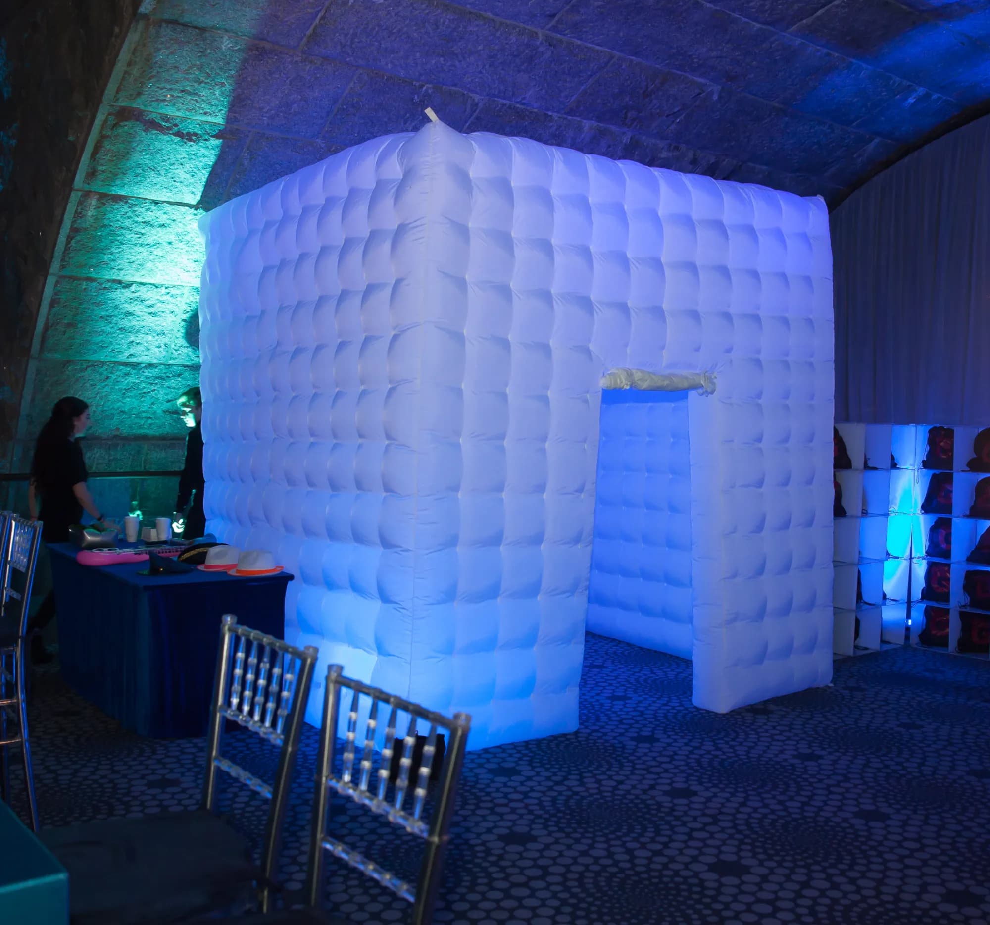 Blue-lit inflatable cube photo booth at a Nicholson Events celebration in New York