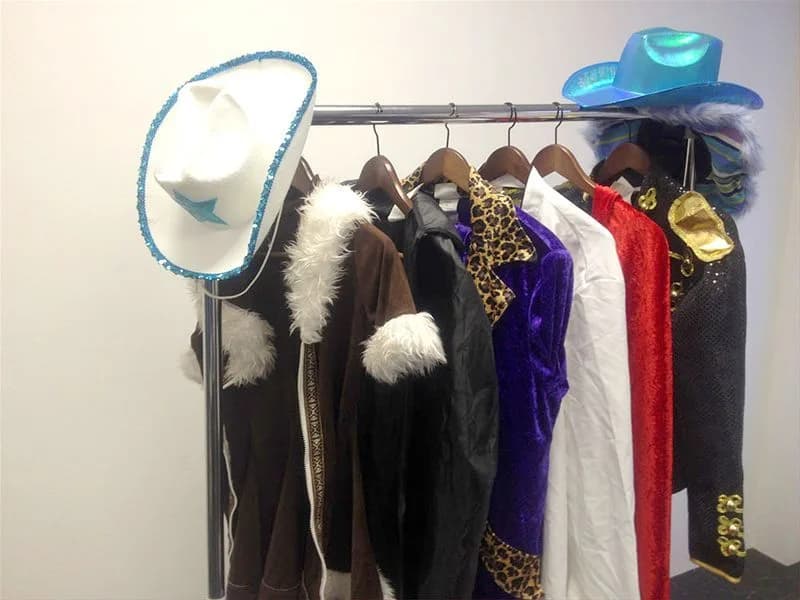 Themed wardrobe rack with costume jackets, hats, and accessories for the fashion shoot activation