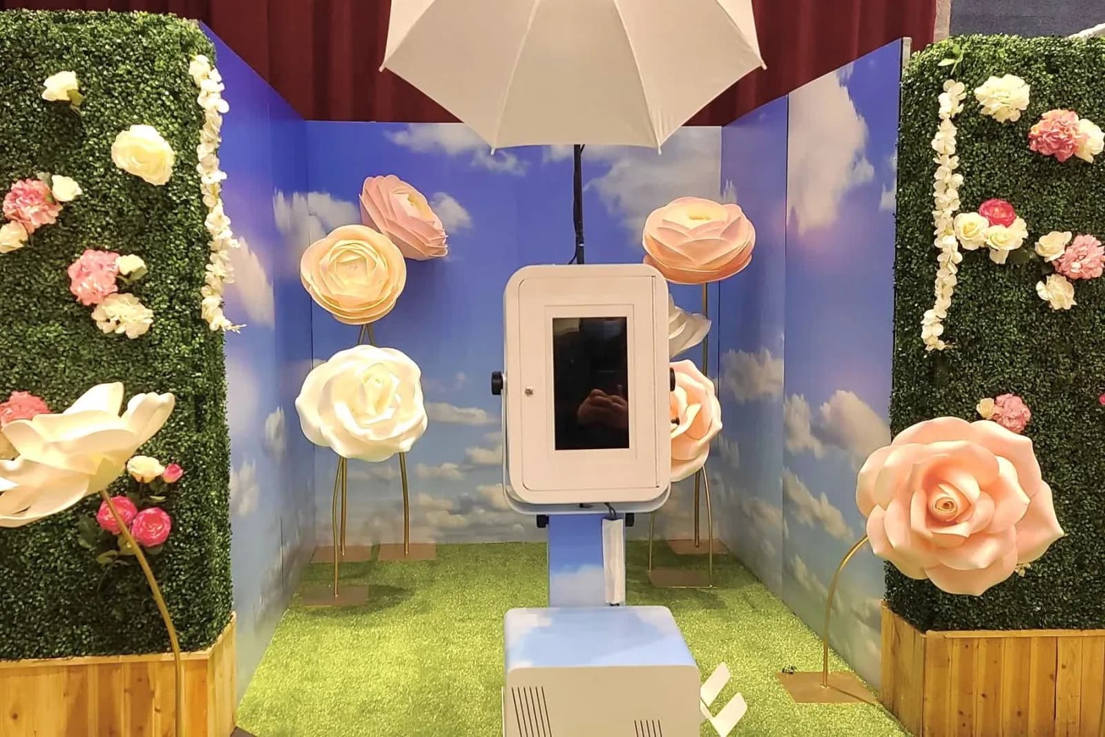 Touch-screen camera unit centered inside the flower immersive experience under a soft-light umbrella