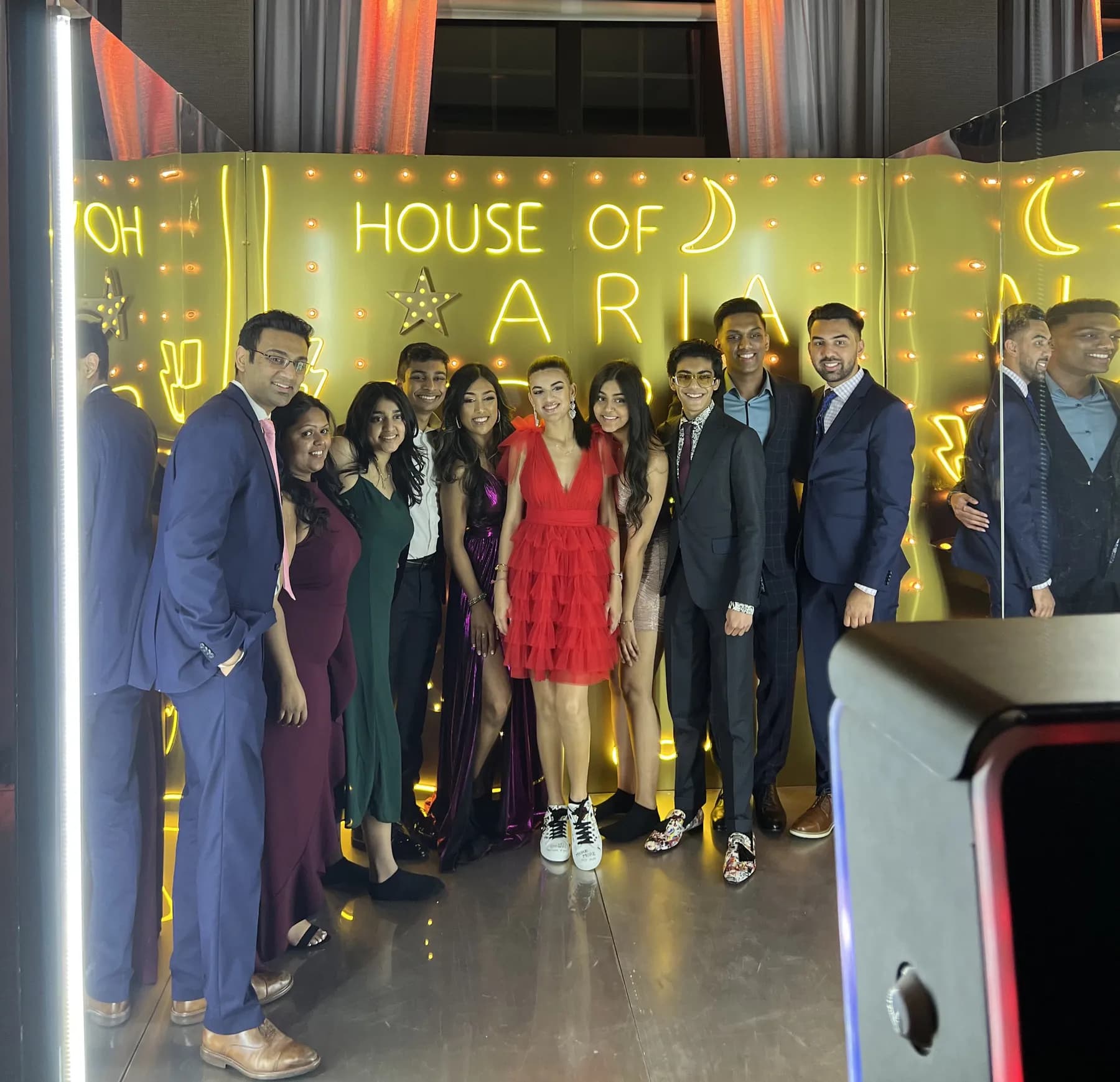 Guests posing inside the Gold Neon Room immersive photo experience at a bar mitzvah in Connecticut
