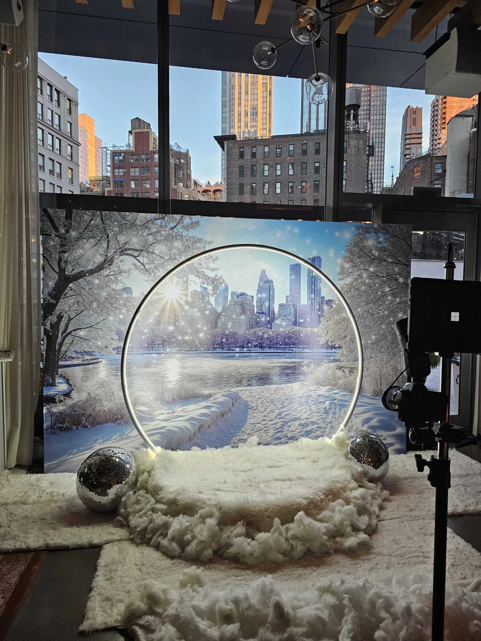 Halo arch snow globe setup with Central Park winter backdrop at a venue