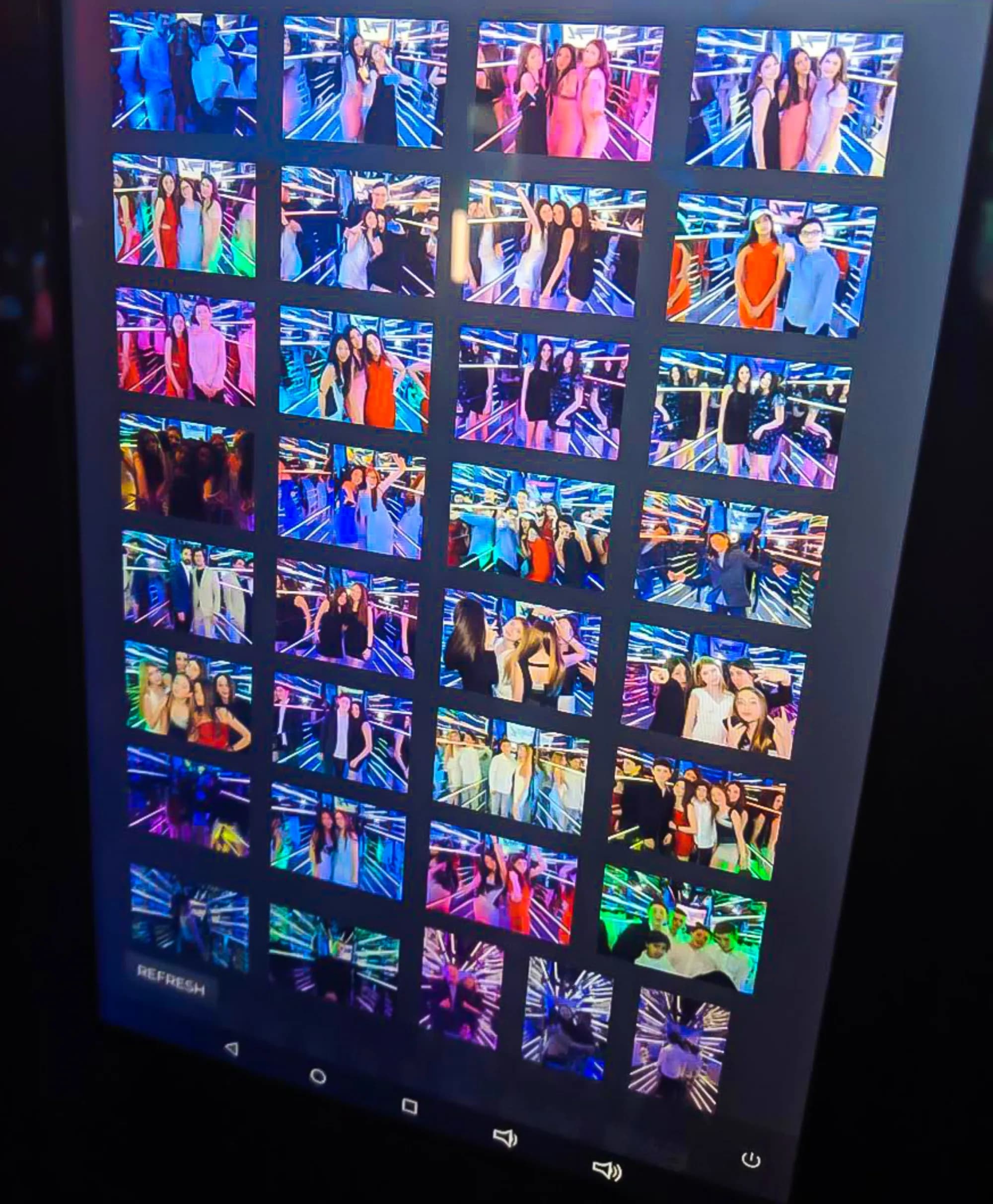 Live photo gallery displaying mirror booth session outputs on a monitor at a corporate event