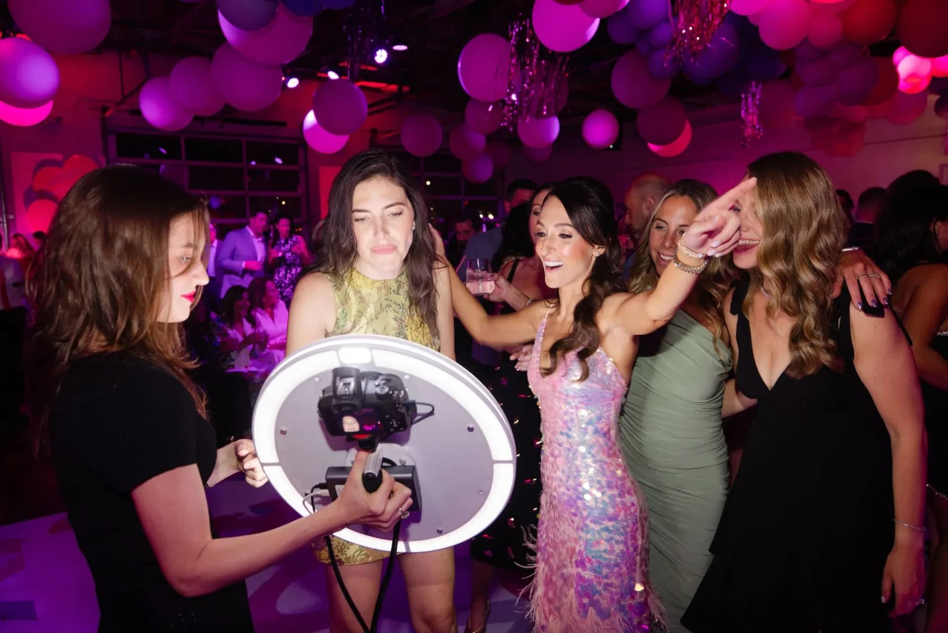 Roaming photo booth attendant capturing candid guest moments at a party event in NYC