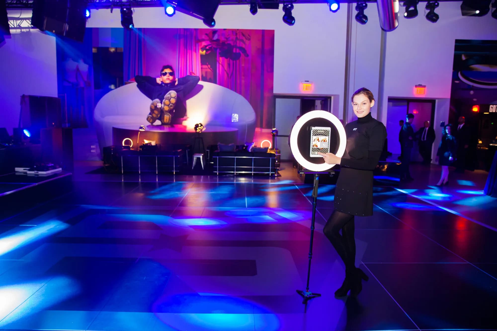 Roaming GIF attendant with ring light on a lit dance floor at a bar mitzvah production