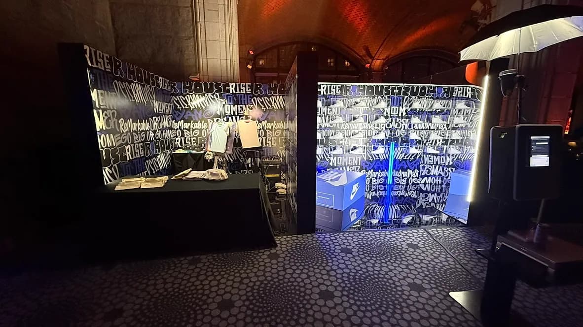 Live airbrush artist station set up at a branded event with custom apparel and graphics by Nicholson Events