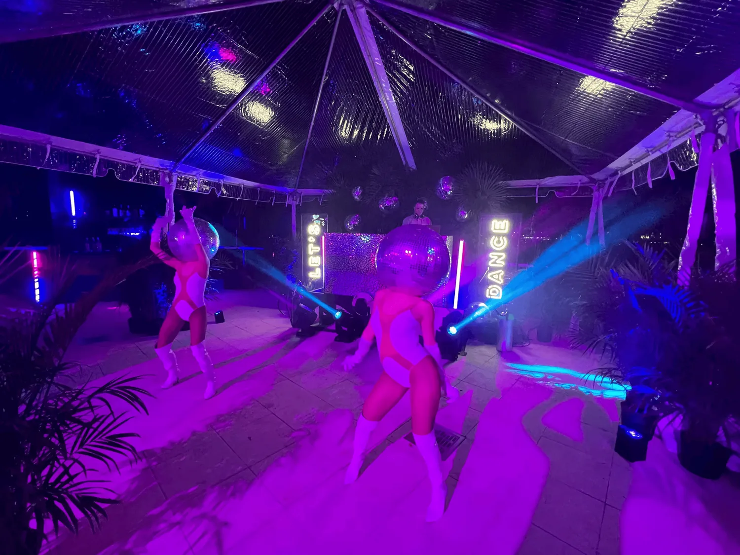 Outdoor tented party with a disco ball and a full dance floor at a silent party by Nicholson Events