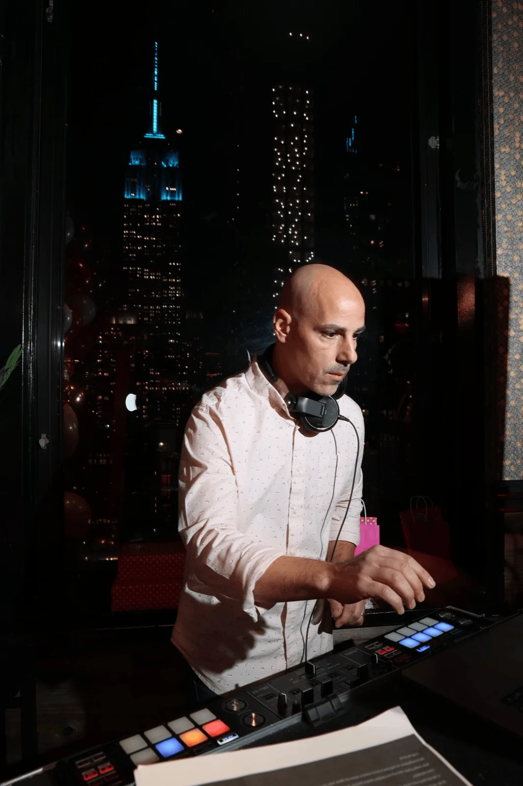 New York wedding DJ performing at the decks with the city skyline behind, for Nicholson Events